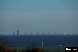 FILE - Reactors of the Zaporizhzhia Nuclear Power Plant, Europe's largest, are seen from the town of Nikopol, in Ukraine's Dnipropetrovsk region, Nov. 7, 2022, amid Russia's ongoing invasion of its neighbor.