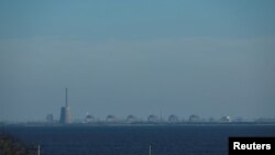 FILE - Reactors of the Zaporizhzhia Nuclear Power Plant, Europe's largest, are seen from the town of Nikopol, in Ukraine's Dnipropetrovsk region, Nov. 7, 2022, amid Russia's ongoing invasion of its neighbor.