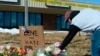 Elijah Newcomb of Colorado Springs lays flowers near a gay nightclub in Colorado Springs, Colo., Nov. 20, 2022 where a shooting occurred late Saturday night. 