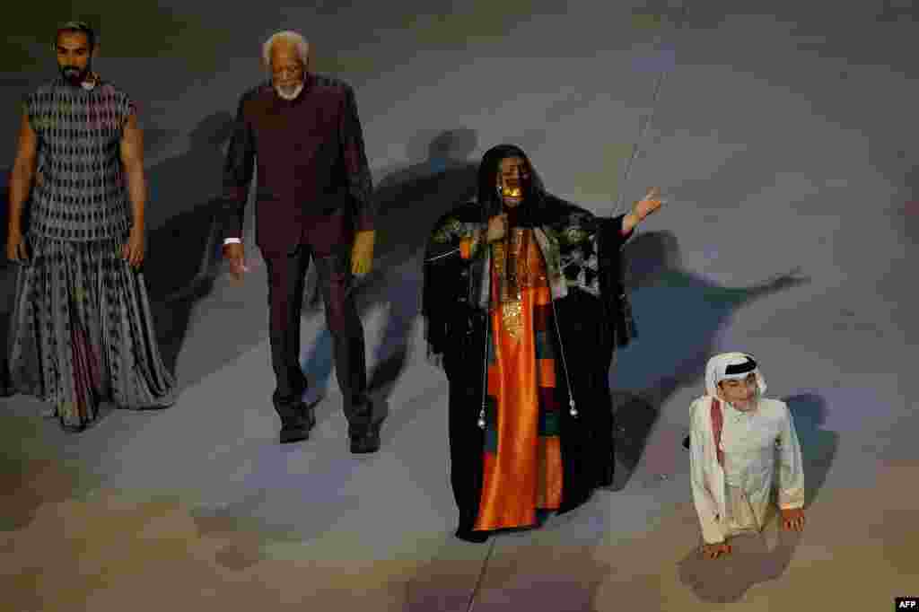 U.S. actor Morgan Freeman (2nd L), Qatari singer Dana al-Fardan (2nd R), and Qatari YouTuber Ghanim al Muftah (R) perform during the opening ceremony ahead of the Qatar 2022 World Cup.