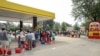 Residents wait in line with gas cans at a Gas Plus gas station in the aftermath of Hurricane Helene, Sept. 29, 2024, in North Augusta, South Carolina. 