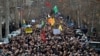 Mourners surround a car carrying the coffins of Iranian Gen. Qasem Soleimani and Iraqi paramilitary chief Abu Mahdi al-Muhandis, killed in a U.S. airstrike, during their funeral procession in a Shiite pilgrimage district of Baghdad.