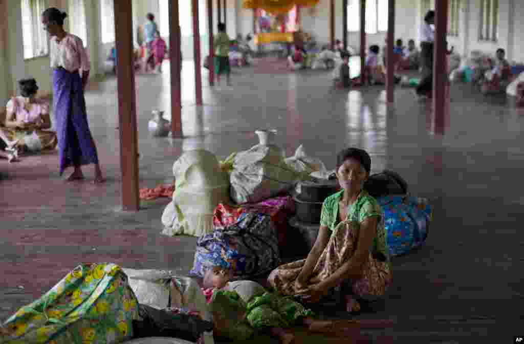 A Rakhine Buddhist woman and her child take in a monastery because of the arrival of the Cyclone Mahasen, Sittwe, Burma, May 14, 2013.