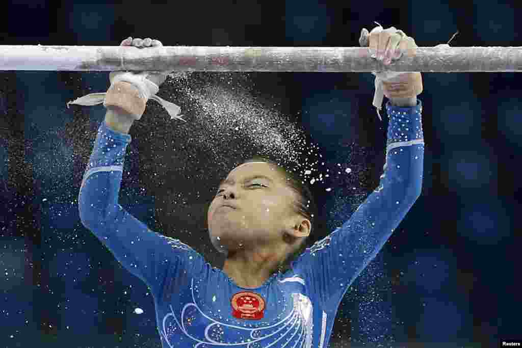 China's Shang Chunsong prepares to compete in the uneven bars event of the women's individual all-around final artistic gymnastics competition at the Namdong Gymnasium Club during the 17th Asian Games in Incheon, South Korea.