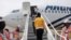 Haitian migrants board a plane as part of the "assisted voluntary return" to Haiti by Mexican authorities, at the Carlos Rovirosa Perez International airport, in Villahermosa, Mexico, Sept. 29, 2021.