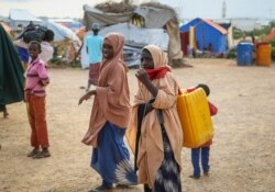 Children displaced by recent floods reach the outskirts of the town of Beledweyne in central Somalia, Nov. 4, 2019.