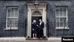 New British Prime Minister Liz Truss and her husband Hugh O'Leary stand outside Downing Street, in London, Sept. 6, 2022.