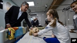 US Secretary of State Antony Blinken gives a gift to Marina, 6, from Kherson region, during a visit to a children hospital in Kyiv, Ukraine, Sept. 8, 2022.