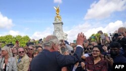 Raja Inggris Charles III menyapa anggota masyarakat yang menunggu di kerumunan setibanya di Istana Buckingham di London, pada 9 September 2022, sehari setelah Ratu Elizabeth II meninggal pada usia 96 tahun. (Foto: AP)