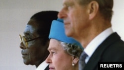 FILE: Queen Elizabeth II and Prince Philip with then-Zimbabwe President Robert Mugabe. Taken 5.20.1994