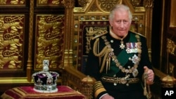 FILE - Prince Charles is seated next to the Queen's crown during the State Opening of Parliament, at the Palace of Westminster in London, May 10, 2022.
