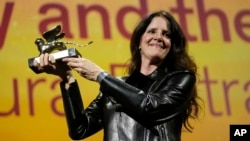 Director Laura Poitras holds the Golden Lion award for best film for "All the Beauty and the Bloodshed" at the closing ceremony of the 79th edition of the Venice Film Festival in Venice, Italy, Sept. 10, 2022.