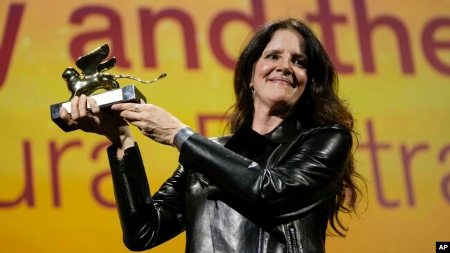 Director Laura Poitras holds the Golden Lion award for best film for