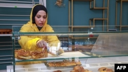 FILE— A staff member arranges baked goods at a bakery which is not subsidised by the Tunisian state, in the capital Tunis, on March 11, 2022.