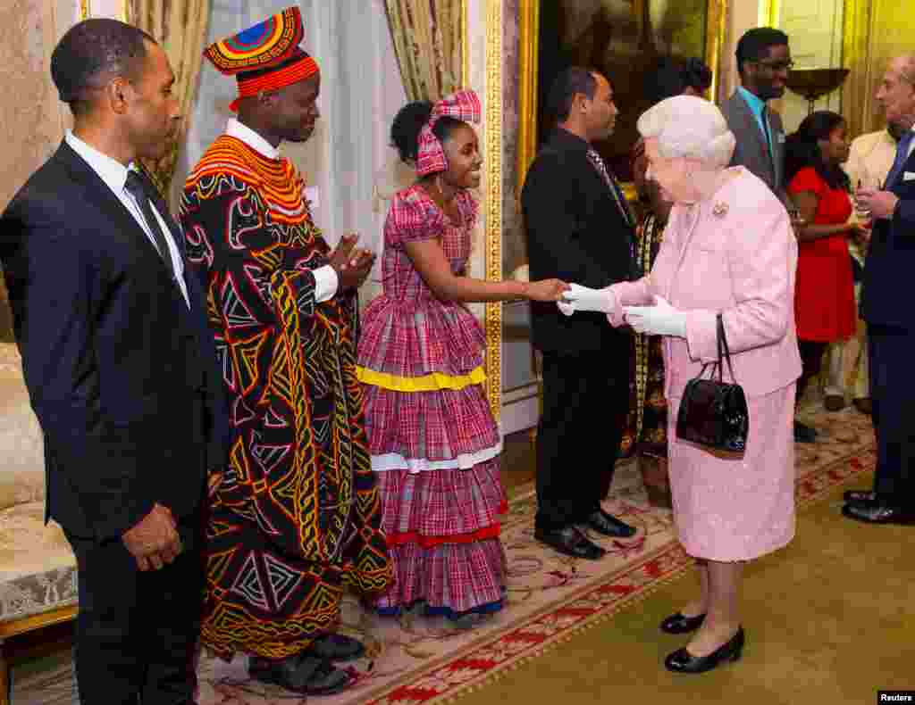 Queen Elizabeth II meets Africa Regional Winner of the Commonwealth Youth Awards Achaleke Christian Leke (2nd L) and Caribbean Regional Winner Shamoy Hajare (3rd L) at the annual Commonwealth Day reception at Marlborough House in London, March 14, 2016.&nbsp;