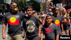 FILE - Protesters take part in a "silent march" during the "Abolish the Date" rally in Sydney, Jan. 26, 2022, to demand that Australia Day, the country's national day, be changed. 