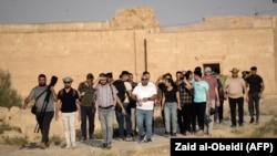 A group of tourists visit the ancient city of Hatra in northern Iraq on Sept. 10, 2022