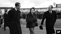 Britain's Princess Elizabeth and her husband Prince Philip, the Duke of Edinburgh, left, cross the tarmac at London Airport, on Jan. 31, 1952, to start their tour of Kenya. It was in Kenya that Elizabeth assumed the throne upon the death of her father, King George VI. 