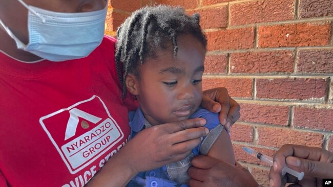 FILE - A child receives a measles vaccination at a clinic in Harare, Zimbabwe, Sept. 6, 2022.