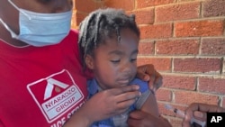 A child receives a measles vaccination jab at a clinic in Harare, Zimbabwe, Sept. 6, 2022.