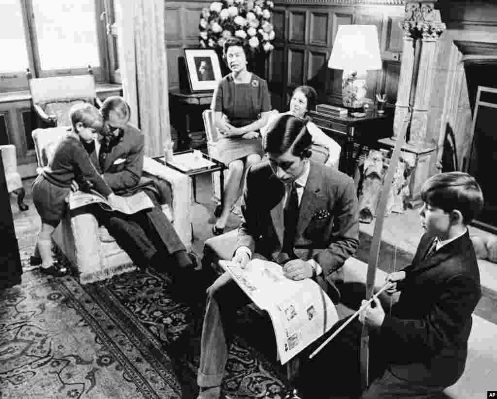 In this previously unpublished 1969 file photo, Queen Elizabeth II, background center and Prince Philip sit with their children Prince Edward, left, Princess Anne, background, Prince Charles, foreground and Prince Andrew, right at Sandringham House, in Sandringham, England.