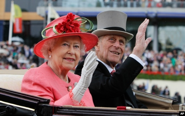 FILE - In this June, 16, 2011 file photo Britain's Queen Elizabeth II with Prince Philip arrive by horse drawn carriage in the parade ring on the third day, traditionally known as Ladies Day, of the Royal Ascot horse race meeting at Ascot, England.