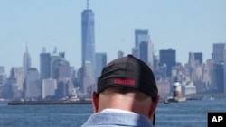Eddie Bracken wears a cap with the word "freedom" while preparing for an interview at the Staten Island September 11th Memorial, in view of lower Manhattan, Sept. 2, 2022, in New York.