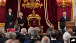 From left, Britain's Prince William, Queen Consort Camilla and King Charles III are seen before Privy Council members in the Throne Room during the Accession Council at St. James's Palace, London, Sept. 10, 2022.