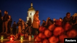 People take part in a rally demanding that Russia be recognized as a state sponsor of terrorism after killing Ukrainian prisoners of war, defenders of the Azovstal Iron and Steel Works in Mariupol, in a prison in Olenivka, outside of Donetsk, Sept. 6, 2022.