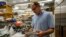 FILE - Biology professor John Dennehy holds a tool for wastewater collection at a lab in Queens College, Aug. 25, 2022, in New York. Since a polio case was identified in July in New York's Rockland County, the disease has been detected in New York City sewage.