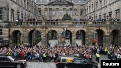 Crowds watch the cortege carrying the coffin of Britain's Queen Elizabeth in Edinburgh, Scotland, Sept. 11, 2022.