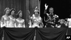 Britain's Queen Elizabeth II and Prince Philip, Duke of Edinburgh, gather with other members of the British royal family to greet supporters from the balcony at Buckingham Palace, following her coronation at Westminster Abbey. London, June. 2, 1953.