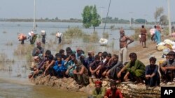 Victims of heavy flooding from monsoon rains wait to receive relief aid from the Pakistani Army in the Qambar Shahdadkot district of Sindh Province, Pakistan, Sept. 9, 2022.