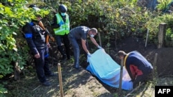 Ukrainian authorities on Sept. 9, 2022 exhumed two bodies in Hrakove, Ukraine, for which they suspect a war crime, in this village taken over by the Ukrainian army from Russian forces on Wednesday.