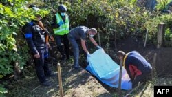 Ukrainian authorities on Sept. 9, 2022 exhumed two bodies in Hrakove, Ukraine, for which they suspect a war crime, in this village taken over by the Ukrainian army from Russian forces on Wednesday.