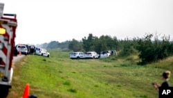 Police and investigators gather at the scene where a stabbing suspect was arrested in Rosthern, Saskatchewan, Sept. 7, 2022. Canadian police arrested Myles Sanderson, the second suspect in the stabbing deaths of multiple people in Saskatchewan, after a three-day manhunt.