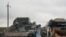 Ukrainian military vehicles move on the road in the freed territory in the Kharkiv region, Ukraine, Monday, Sept. 12, 2022.