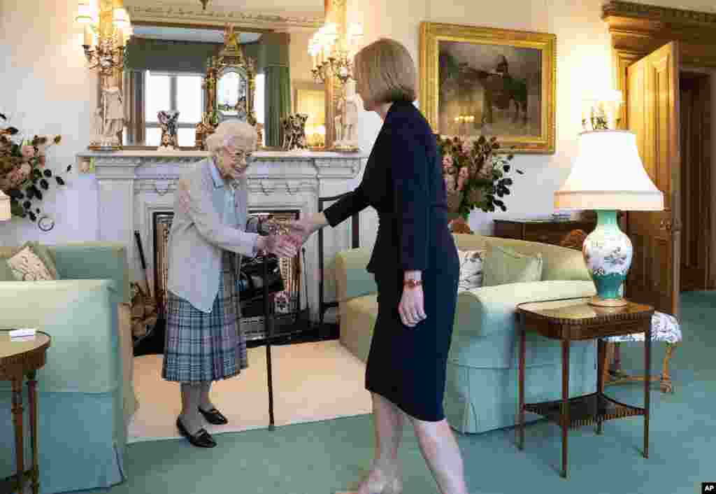 Britain&#39;s Queen Elizabeth II, left, welcomes Liz Truss during an audience at Balmoral, Scotland, where she invited the newly elected leader of the Conservative party to become Prime Minister and form a new government.