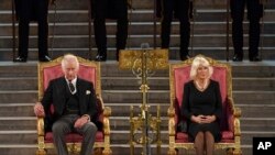 King Charles III and Camilla, the Queen Consort sit at Westminster Hall in London, Sept. 12, 2022.