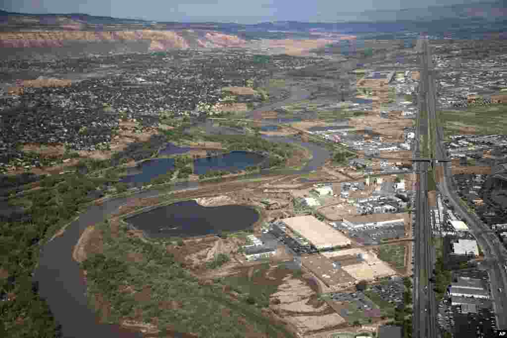FILE - The Colorado River passes through Grand Junction, Aug. 24, 2022, in Mesa County, Colo. In November 1922, seven land-owning white men brokered a deal to allocate water from the Colorado River, which winds through the West and ends in Mexico. 