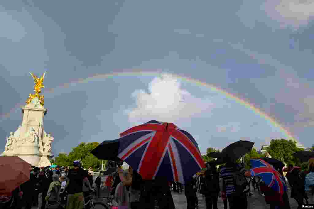 A double rainbow forms as people gather outside Buckingham Palace, following a statement from the Palace over concerns for Britain's Queen Elizabeth's health, in London, Britain. The Palace later announced the Queen's death.