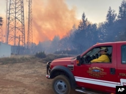 FILE - Climate change delivers drier conditions to the Pacific Northwest which requires different strategies for battling wildfires, like this one near Salem, Ore., Sept. 9, 2022.