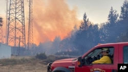 FILE - Climate change delivers drier conditions to the Pacific Northwest which requires different strategies for battling wildfires, like this one near Salem, Ore., Sept. 9, 2022.