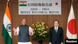 India’s defense minister, Rajnath Singh, and Japan's defense minister, Yasukazu Hamada, pose for photographs prior to the Japan-India bilateral defense meeting at the Japanese Defense Ministry in Tokyo, Sept. 8, 2022. 