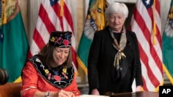 Treasury Secretary Janet Yellen watches as Treasurer Lynn Malerba's signature is copied for U.S. currency, Sept. 12, 2022, in Washington.