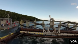 ORPC's generator being positioned in a river in Alaska.