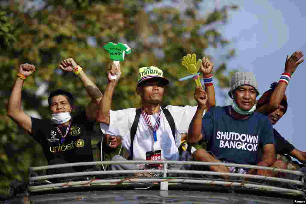 Anti-government protesters travel atop a bus near the Interior Ministry building in Bangkok, Feb. 5, 2014. 