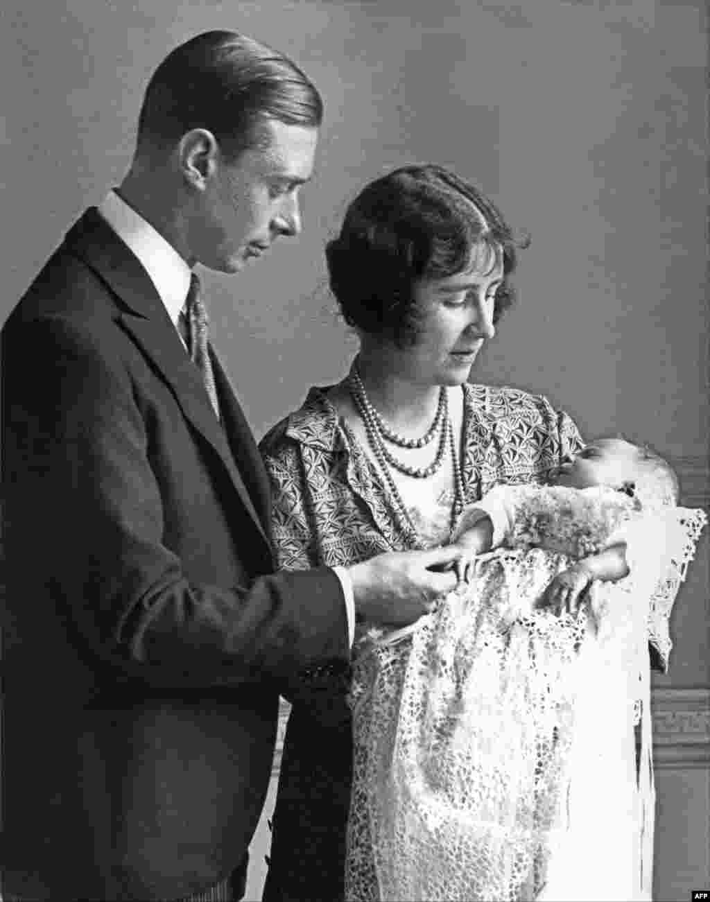 The Duchess of York, right, holds in 1926 in London her firstborn, Princess Elizabeth, under the loving gaze of her husband, the Duke of York and future King George VI. Elizabeth was born on April 21, 1926.