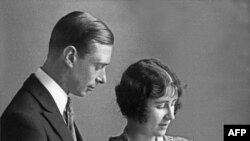 Lady Elizabeth Angela Marguerite Bowes-Lyon, the daughter of the 14th Earl of Strathmore, the Duchess of York (R) holds in 1926 in London her firstborn, Princess Elizabeth under the loving gaze of her husband, the Duke of York. She was born on April 21, 1