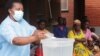 FILE - A health worker educates communities on how to mix chlorine with water as a preventive measure against spread of cholera, in Blantyre, Malawi. (Lameck Masina/VOA)
